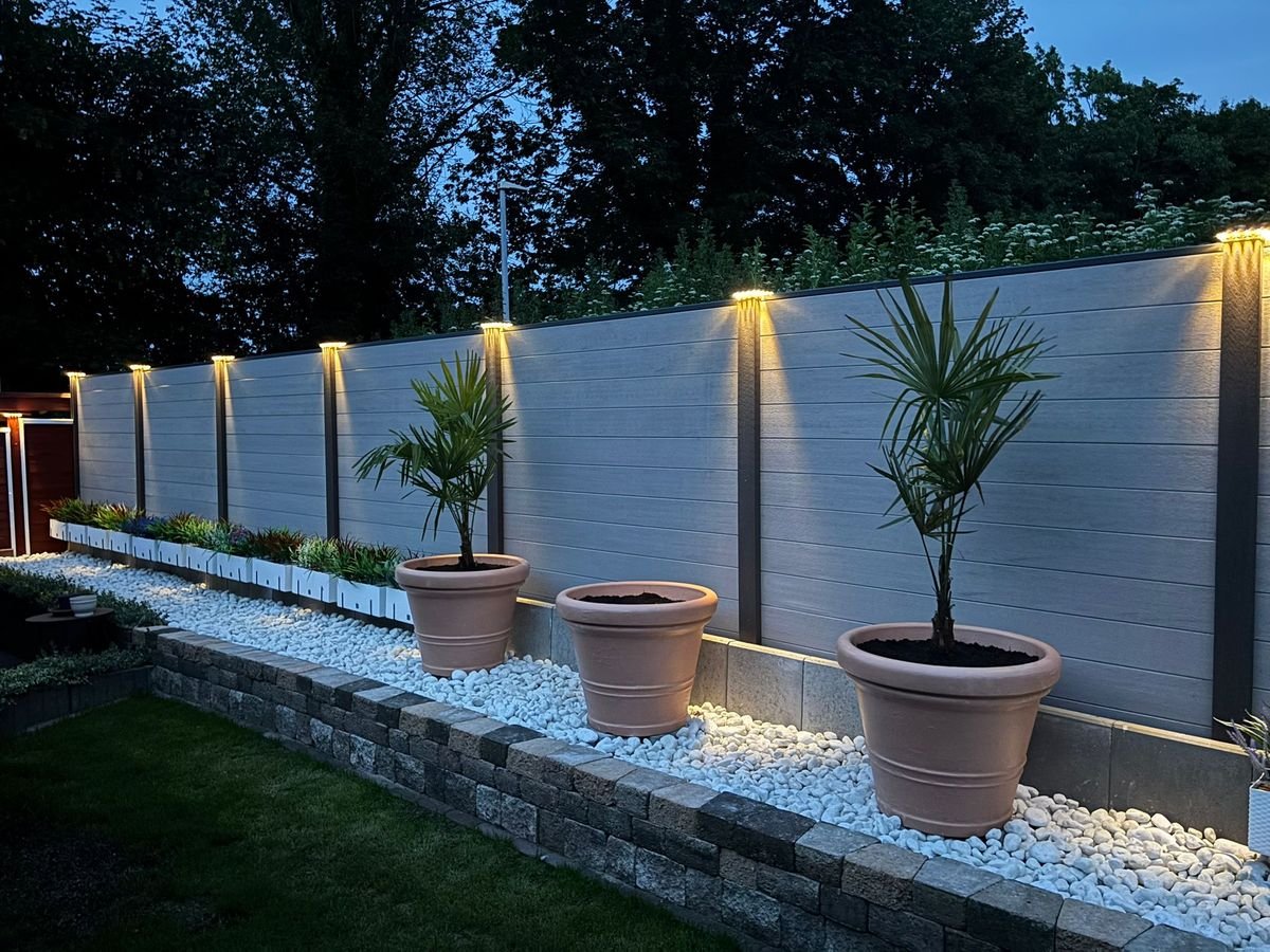 Sichtschutzzaun mit Beleuchtung, Kieselbeet und Palmen – Gartengestaltung von STERKALAND Lübeck